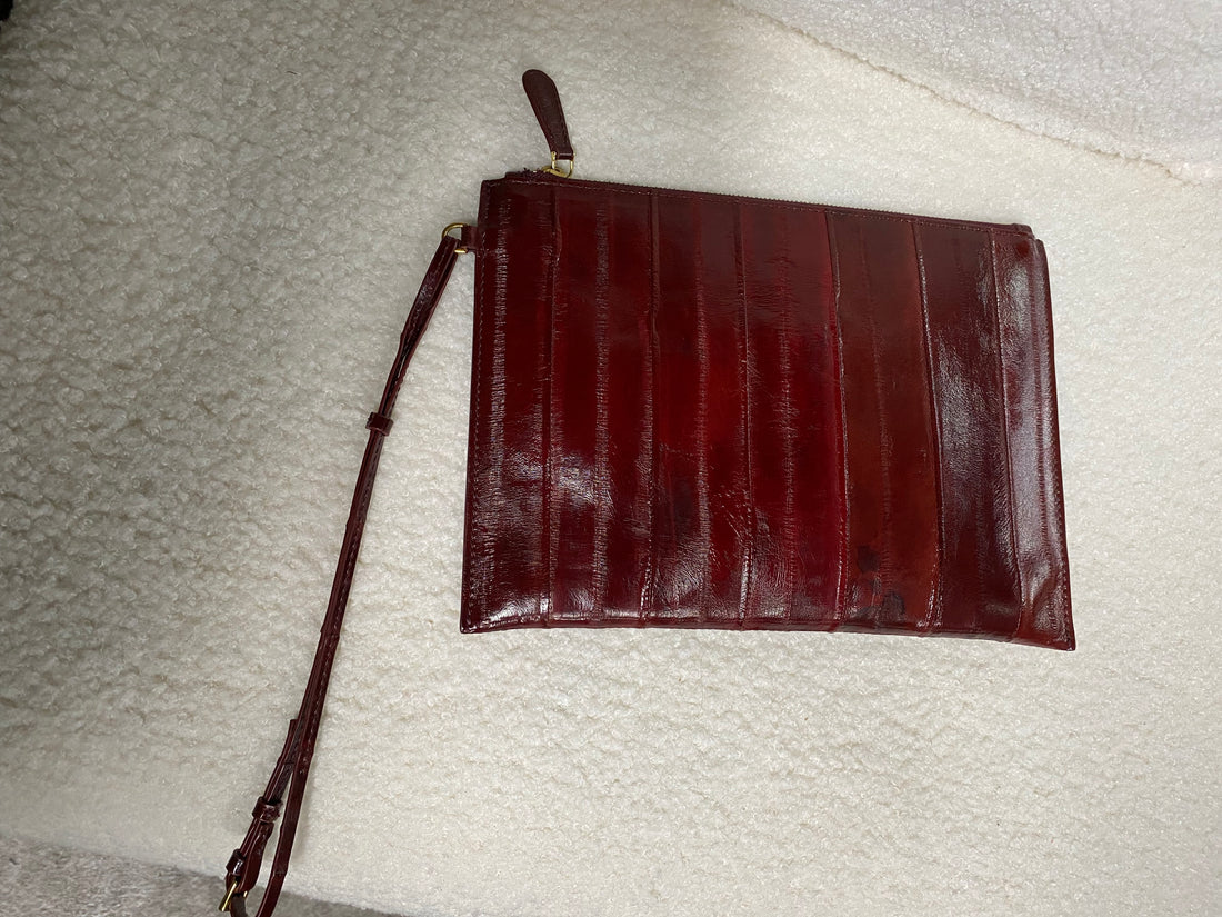 Burgundy genuine eel leather envelope clutch — front view with wrist strap