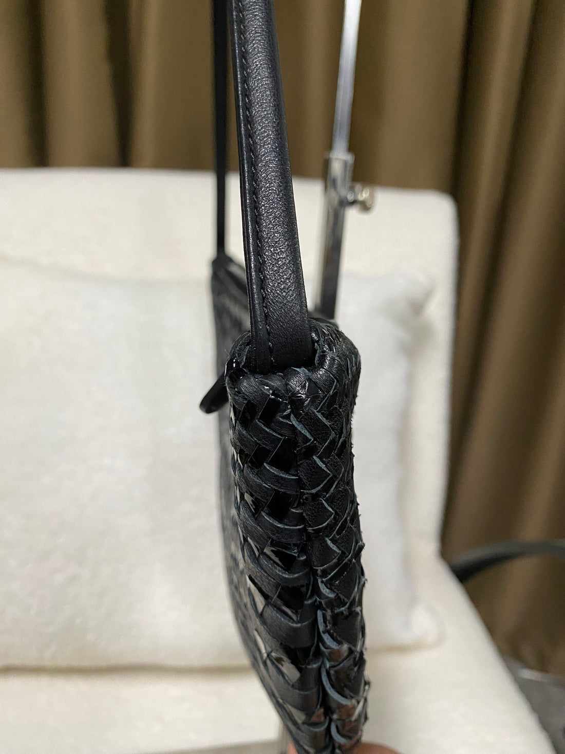 Side profile showing woven leather construction and shoulder strap