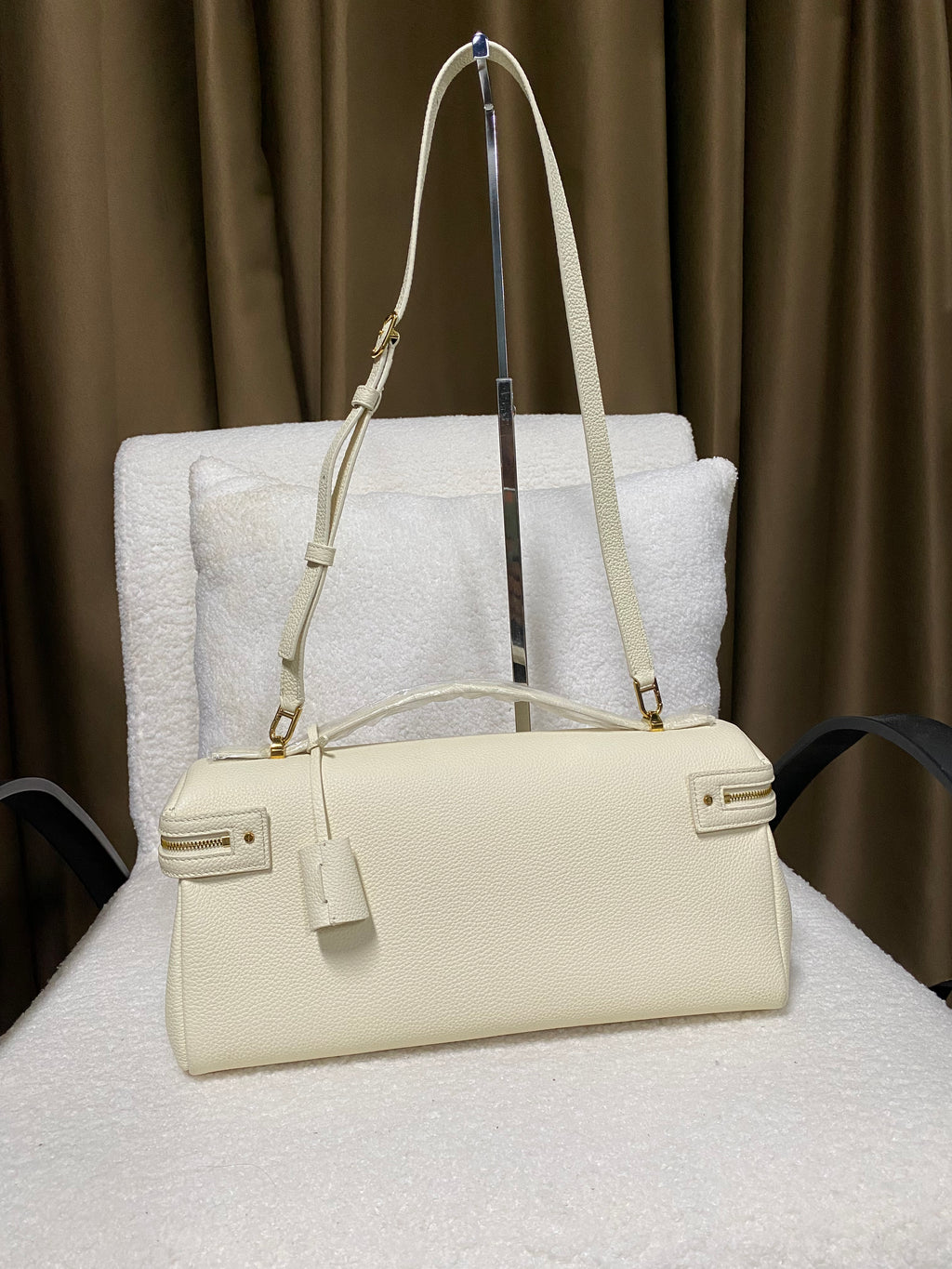 Cream white leather handbag back view with shoulder strap