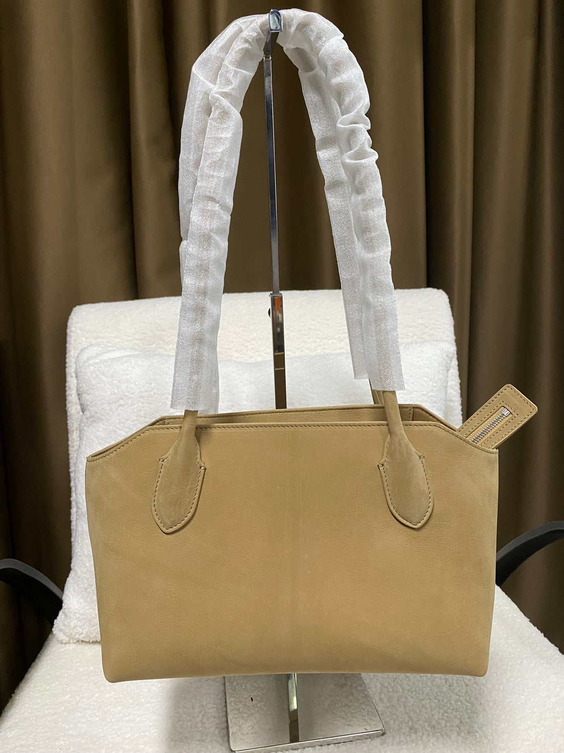 Warm tan baby calfskin tote bag on display