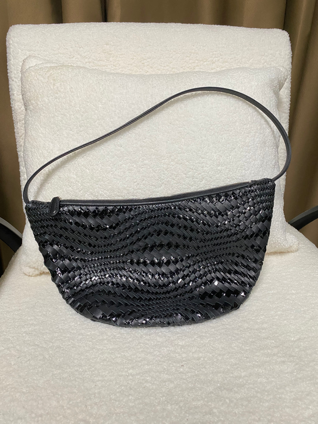 Black woven full-grain leather hobo bag back view