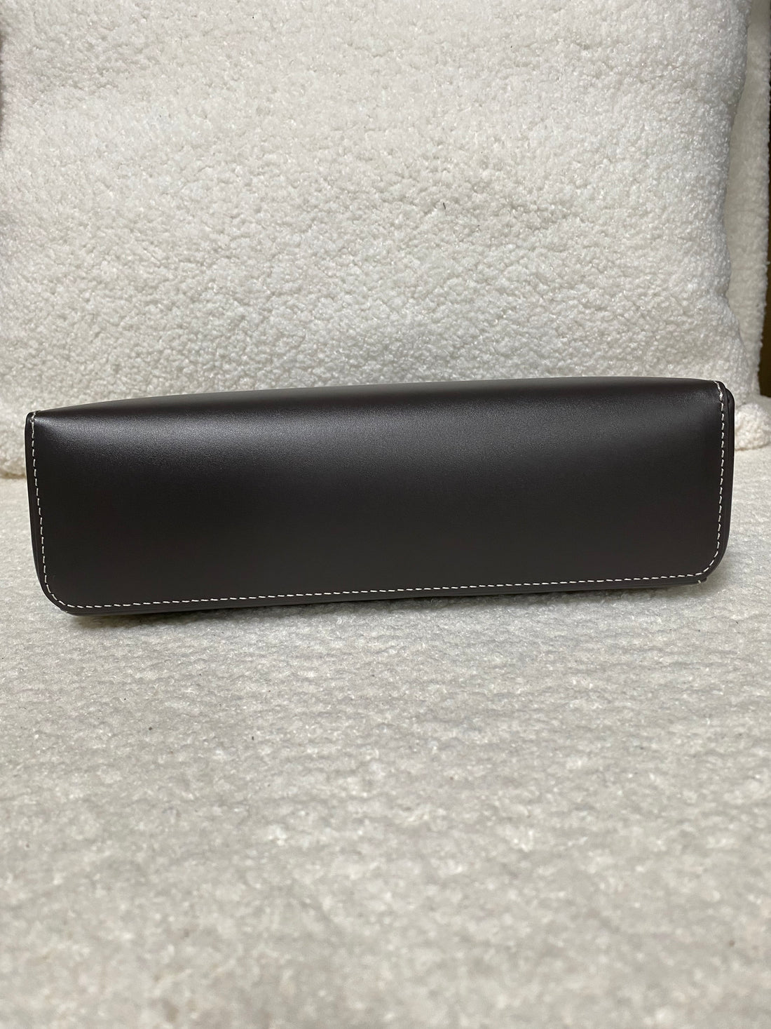 Flat leather base of dark brown calfskin box shoulder bag