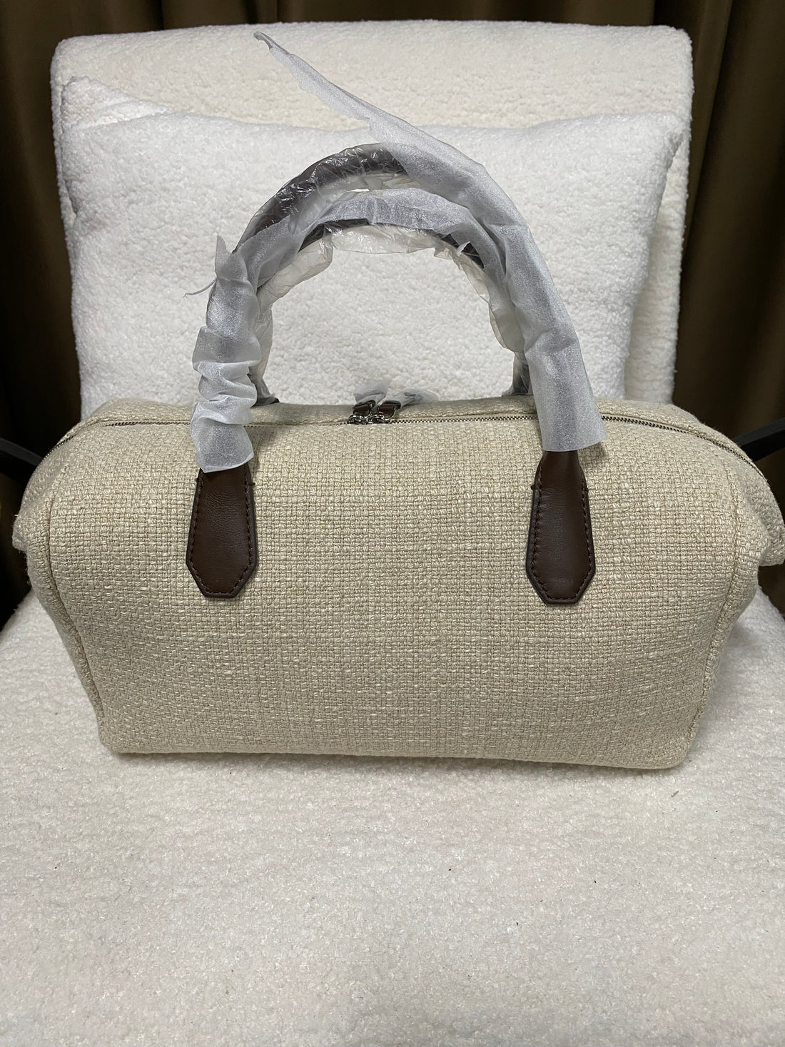 Off-white linen Boston bag front view with full-grain leather handles
