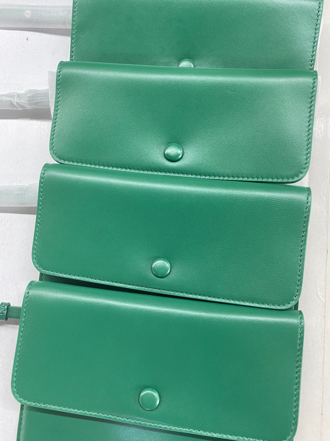 Emerald green detachable leather pouch close-up