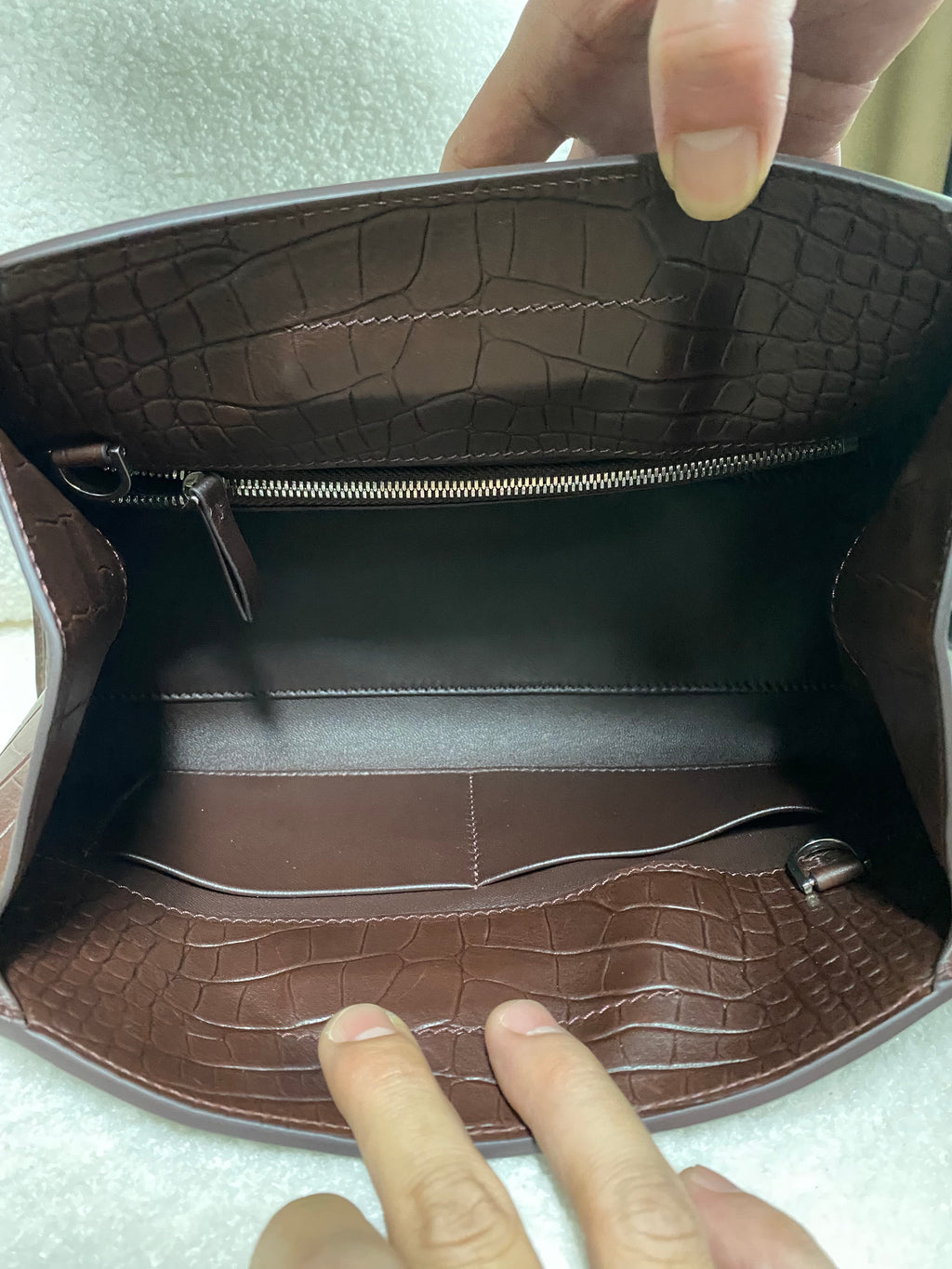 Open interior of dark brown croc-embossed leather shoulder bag