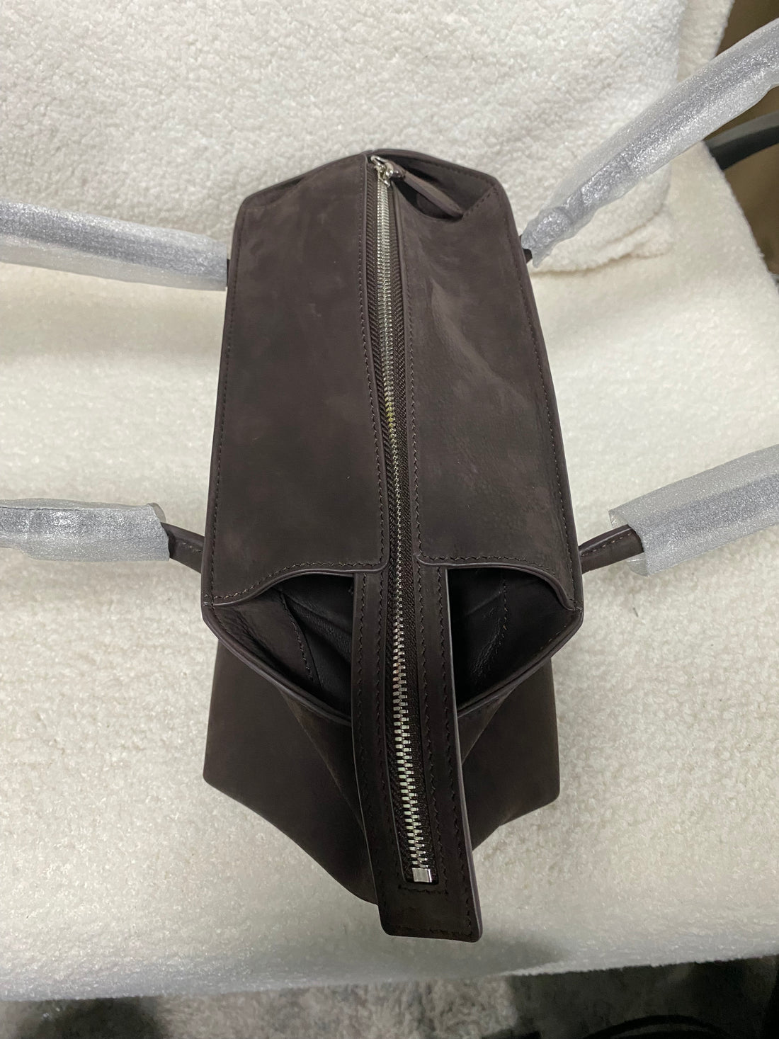 Dark brown calfskin tote side profile with top zipper
