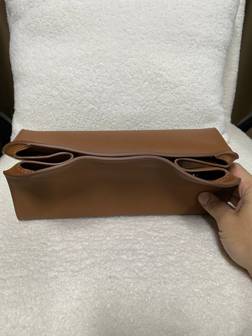 Brown leather shoulder bag top and side construction detail