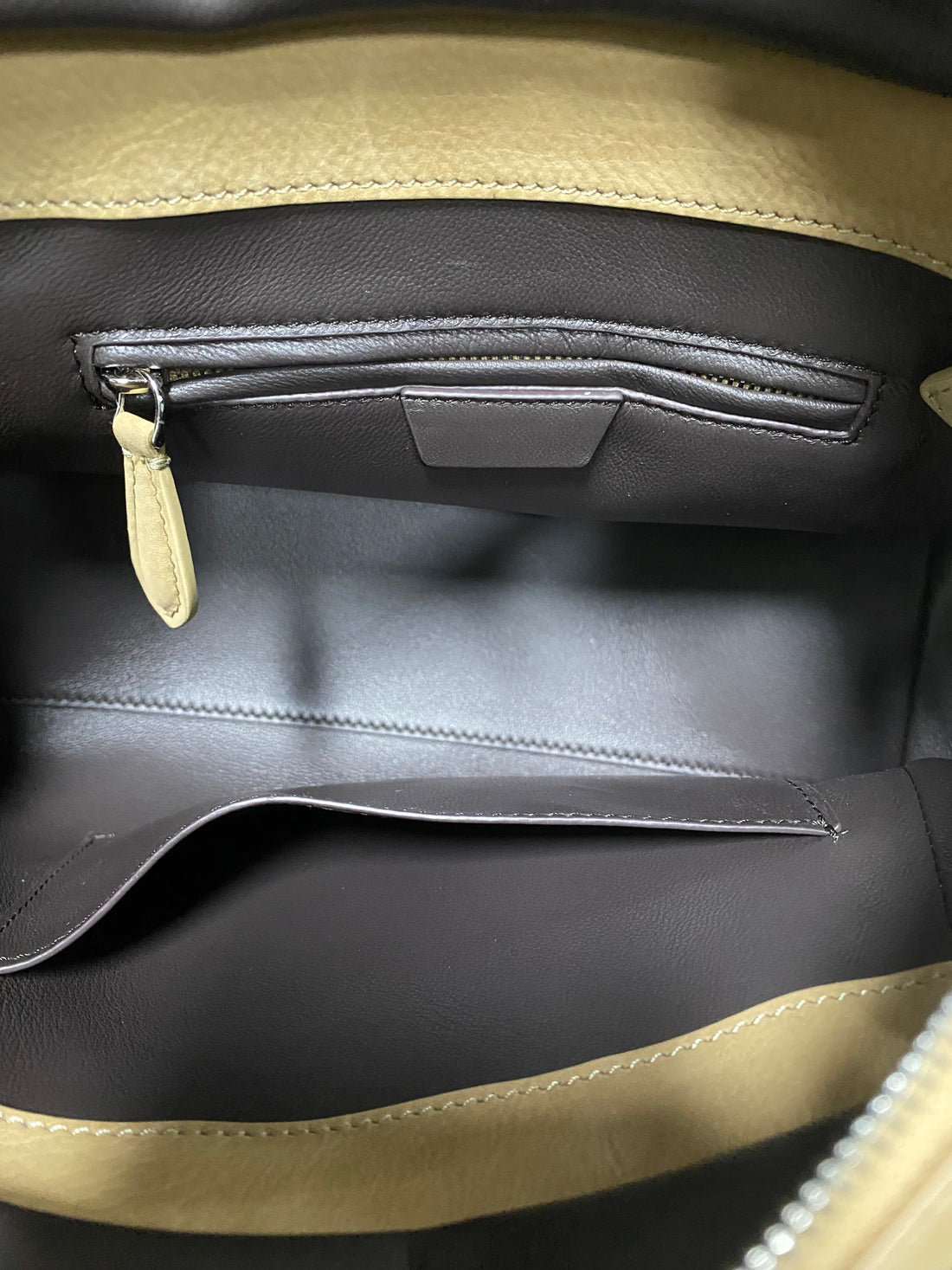 Grey leather-lined interior with zipper pocket inside calfskin tote