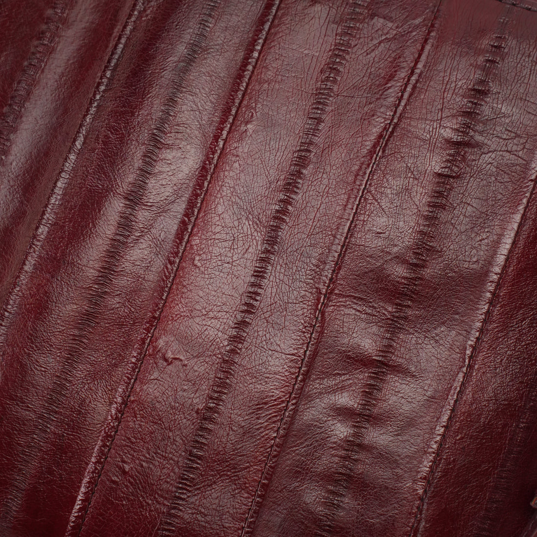 Burgundy genuine eel leather envelope clutch — eel leather striped texture close-up