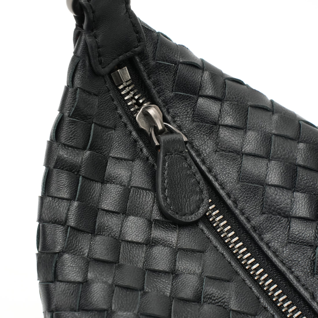 Logo-free handwoven lambskin shoulder bag — black zipper and woven leather close-up