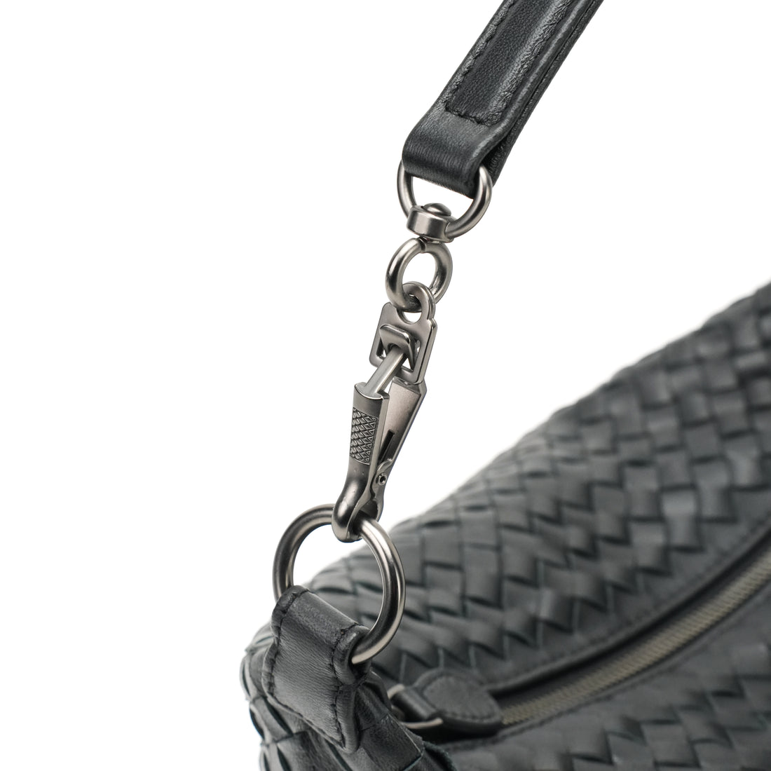 Logo-free handwoven lambskin shoulder bag — black strap clasp close-up