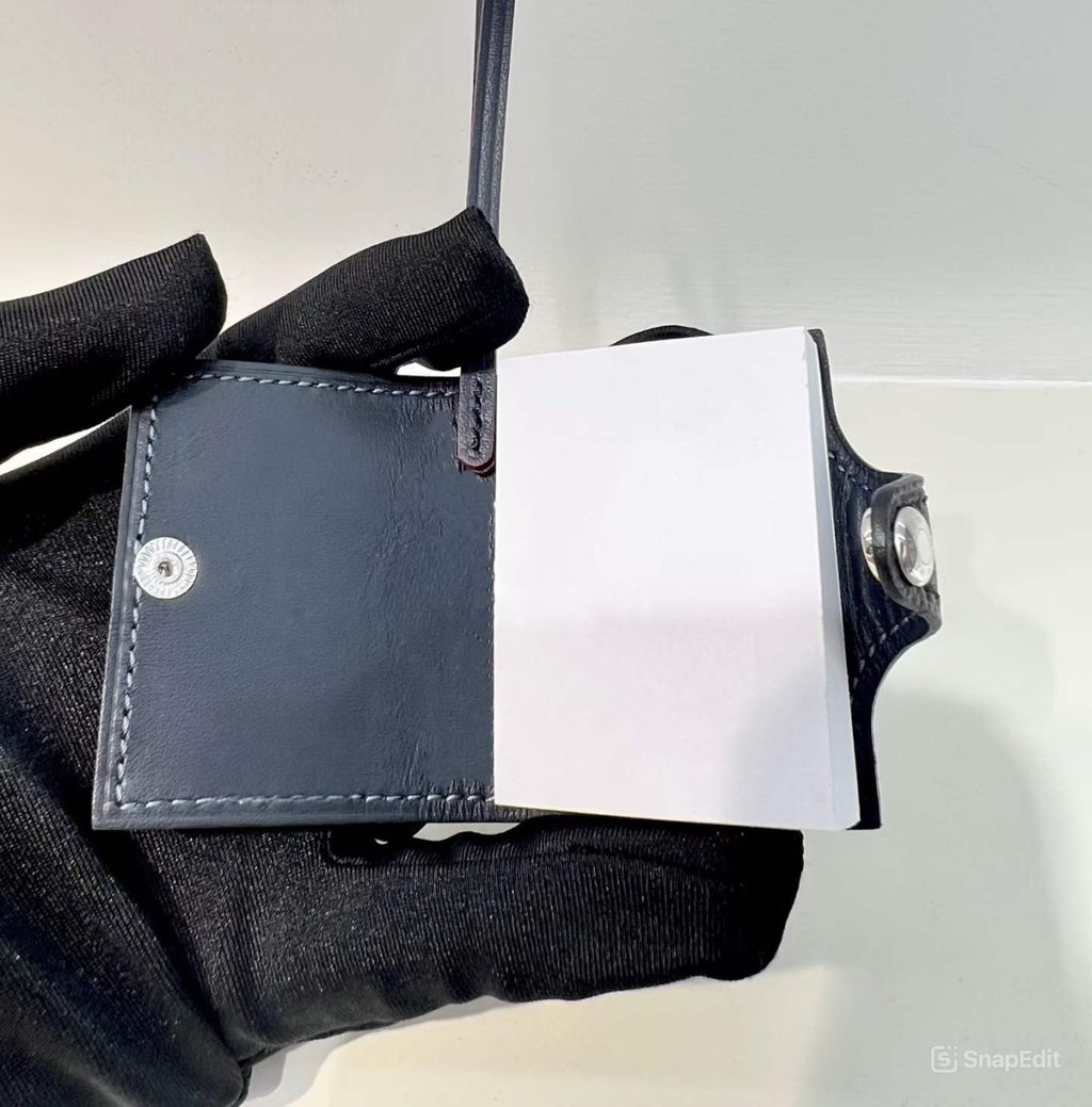 Inside view of black hand-stitched leather mini notebook bag charm