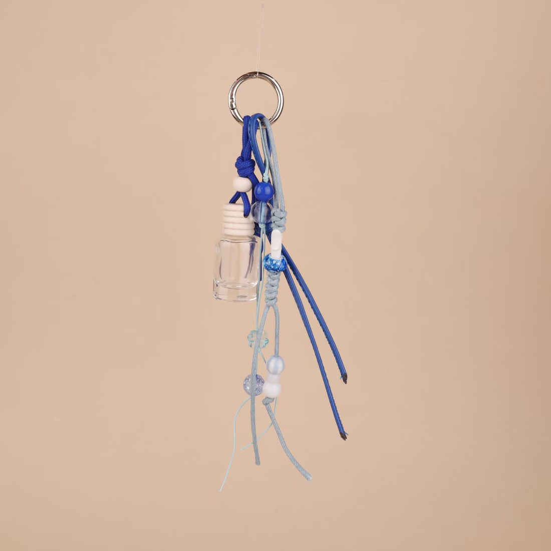Blue beaded rope bag charm with mini clear glass bottle and silver ring