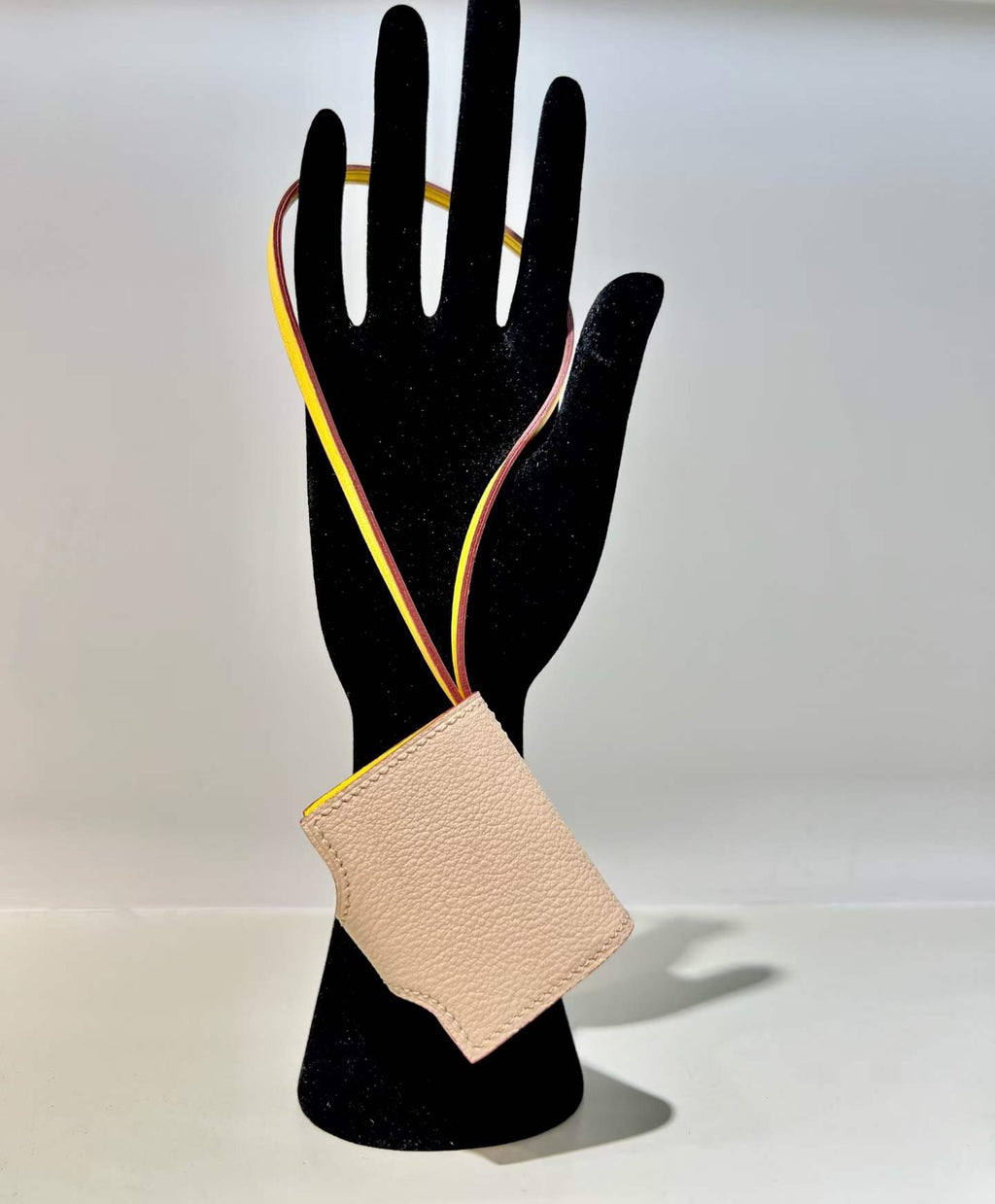 Back view of blush pink hand-stitched leather book bag charm