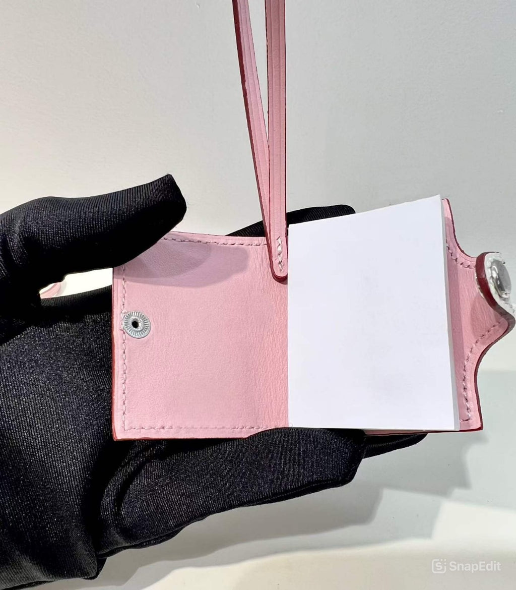 Inside view of blush pink hand-stitched leather mini notebook bag charm