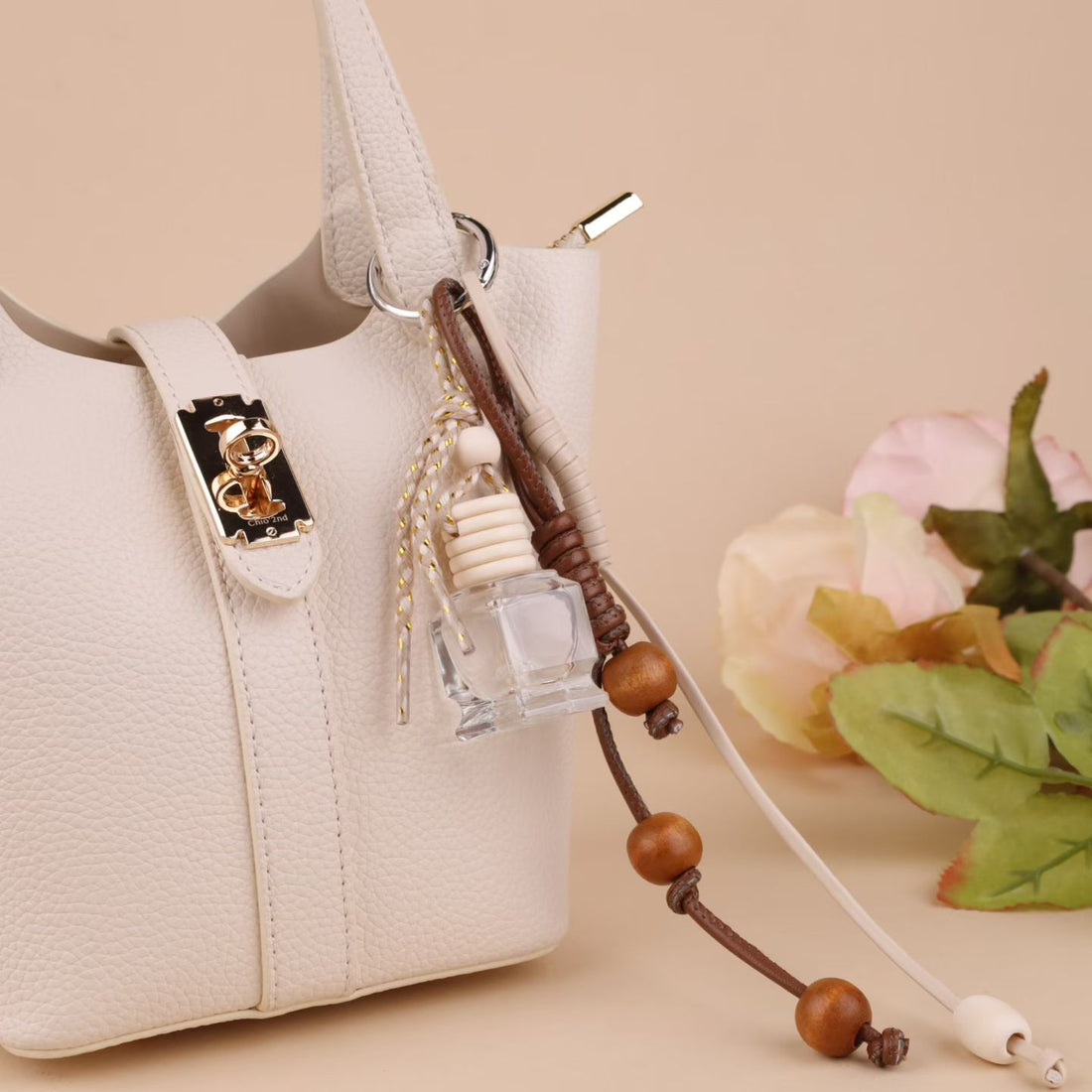 Brown and cream rope bag charm with wooden beads and mini glass bottle