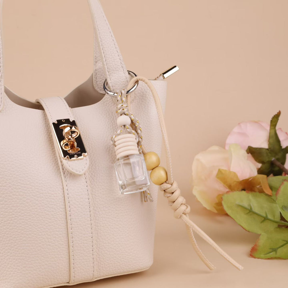 Cream rope bag charm with gold thread, wooden beads and mini glass bottle