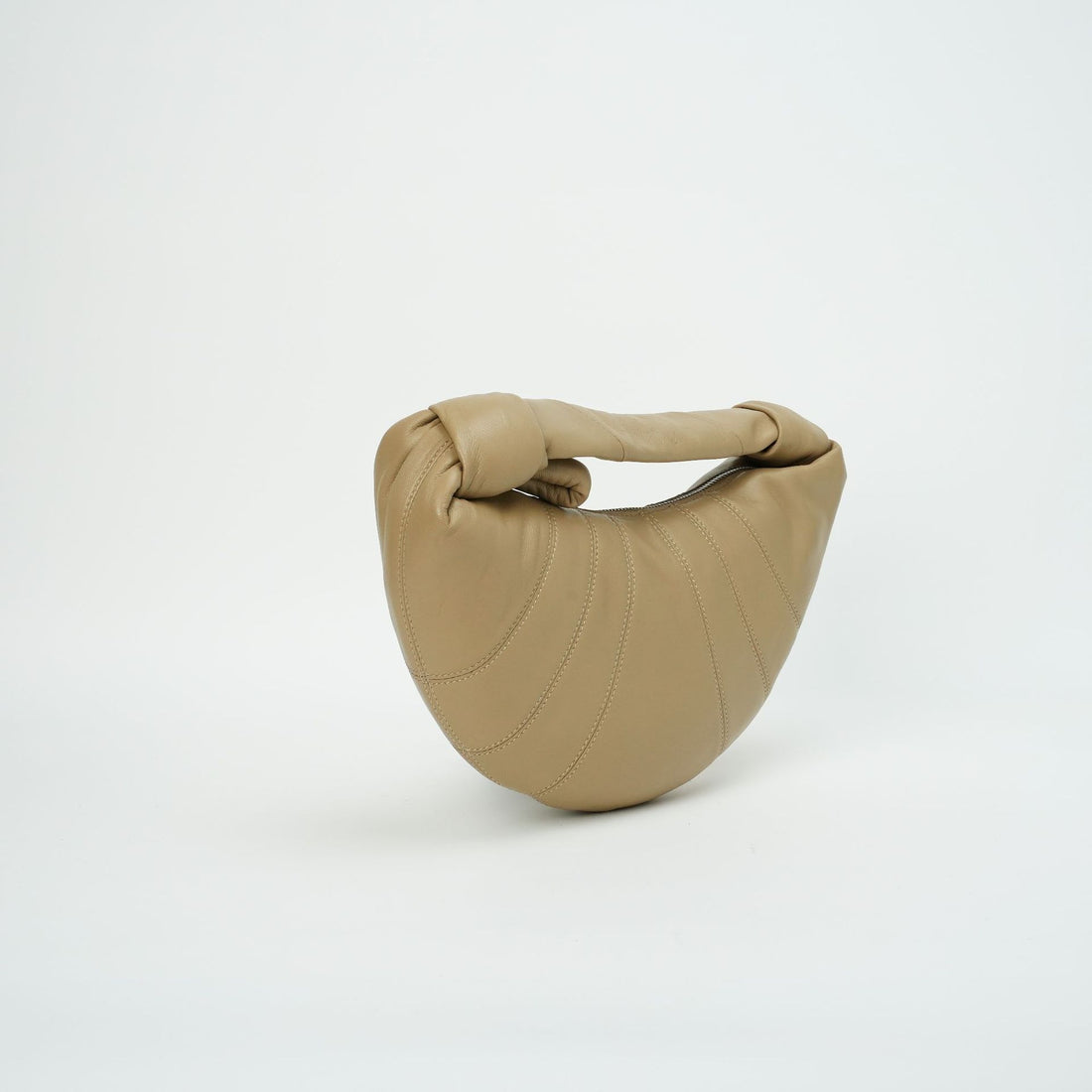 Logo-free lambskin croissant shoulder bag — tan front view on white