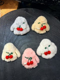Fluffy bunny bag charms with knitted red cherry details in five colors