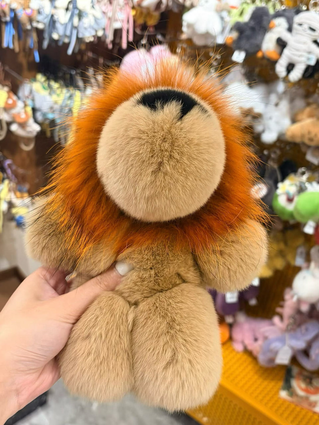 Golden ochre fluffy lion bag charm with soft rounded paws and long mane