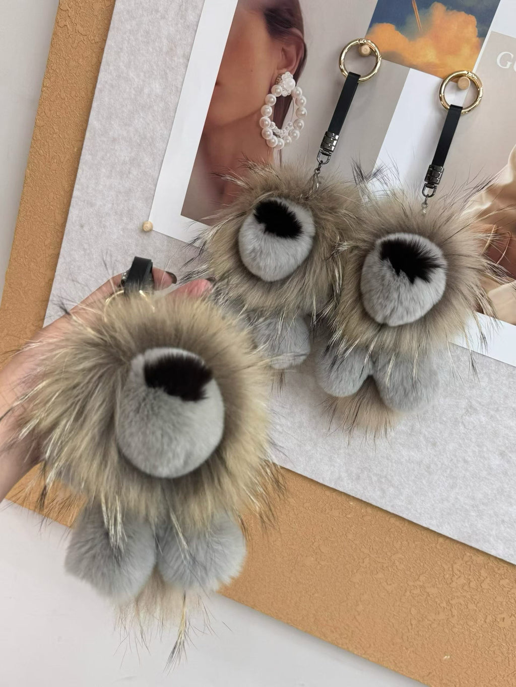 Neutral fluffy lion bag charms in sand tan and silver gray