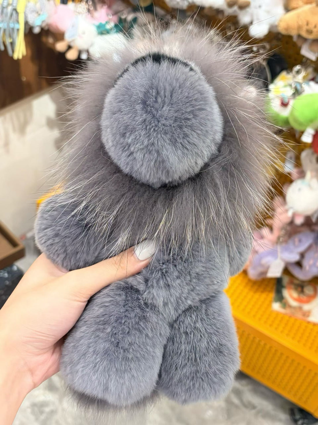 Silver gray fluffy lion bag charm close-up with long wispy mane