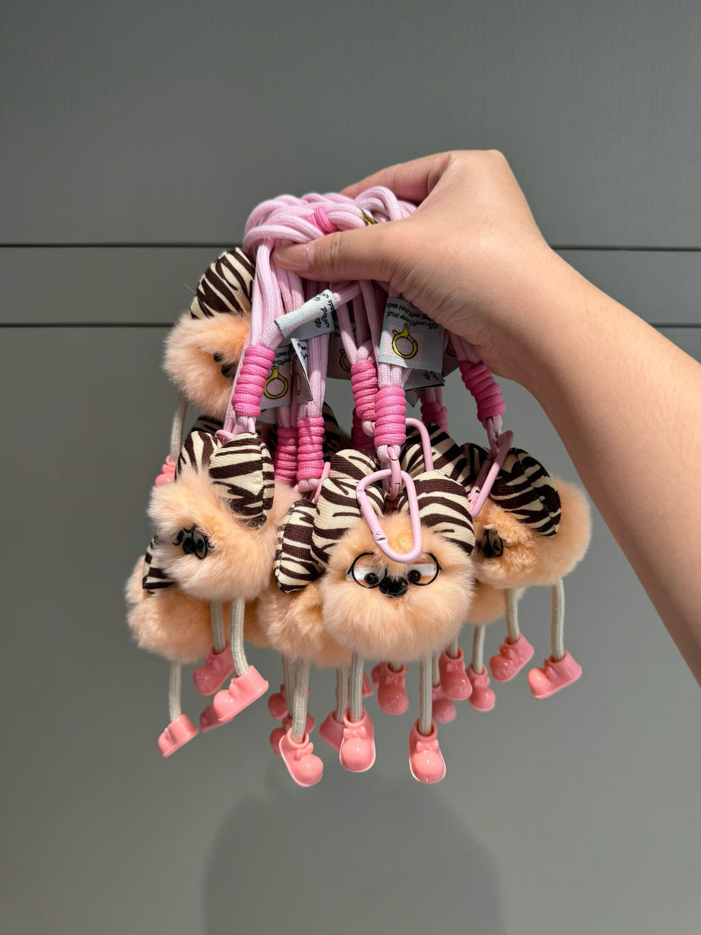 Peach fluffy character bag charm with zebra bow glasses and pink rope loop