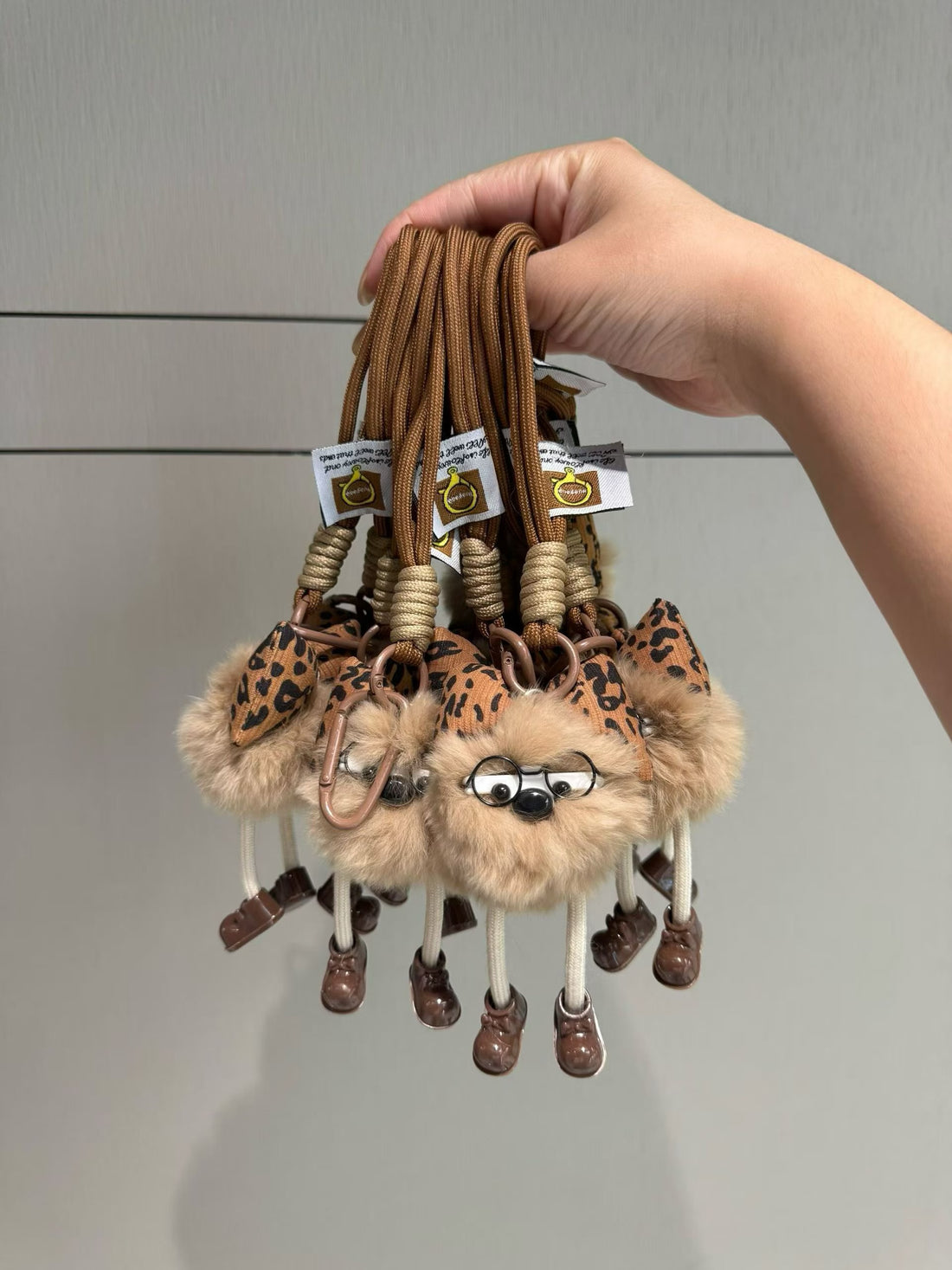 Tan fluffy character bag charm with leopard bow glasses and rope loop