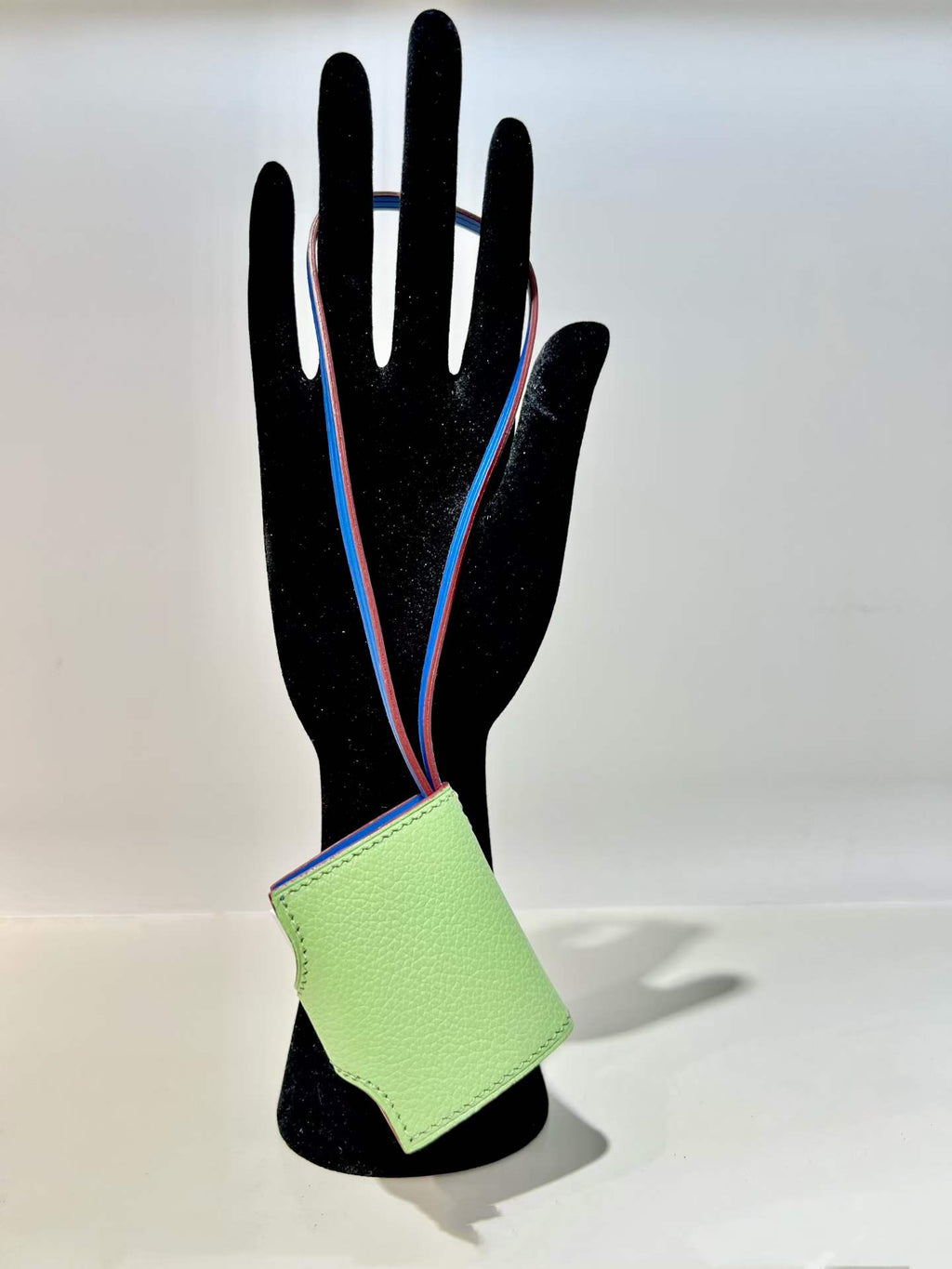 Back view of mint green hand-stitched leather book bag charm