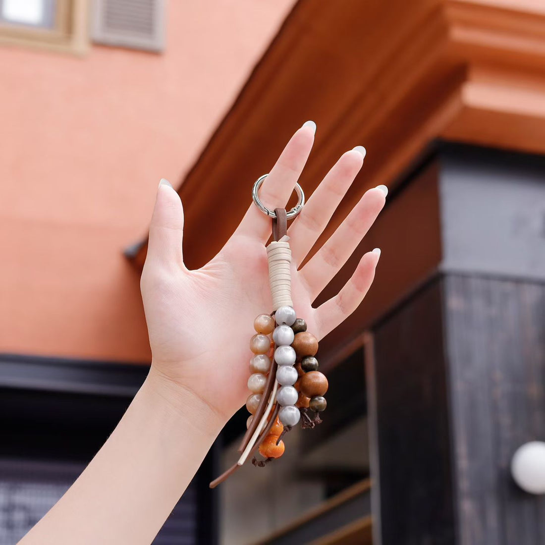 Mixed bead bag charm shown in hand for scale