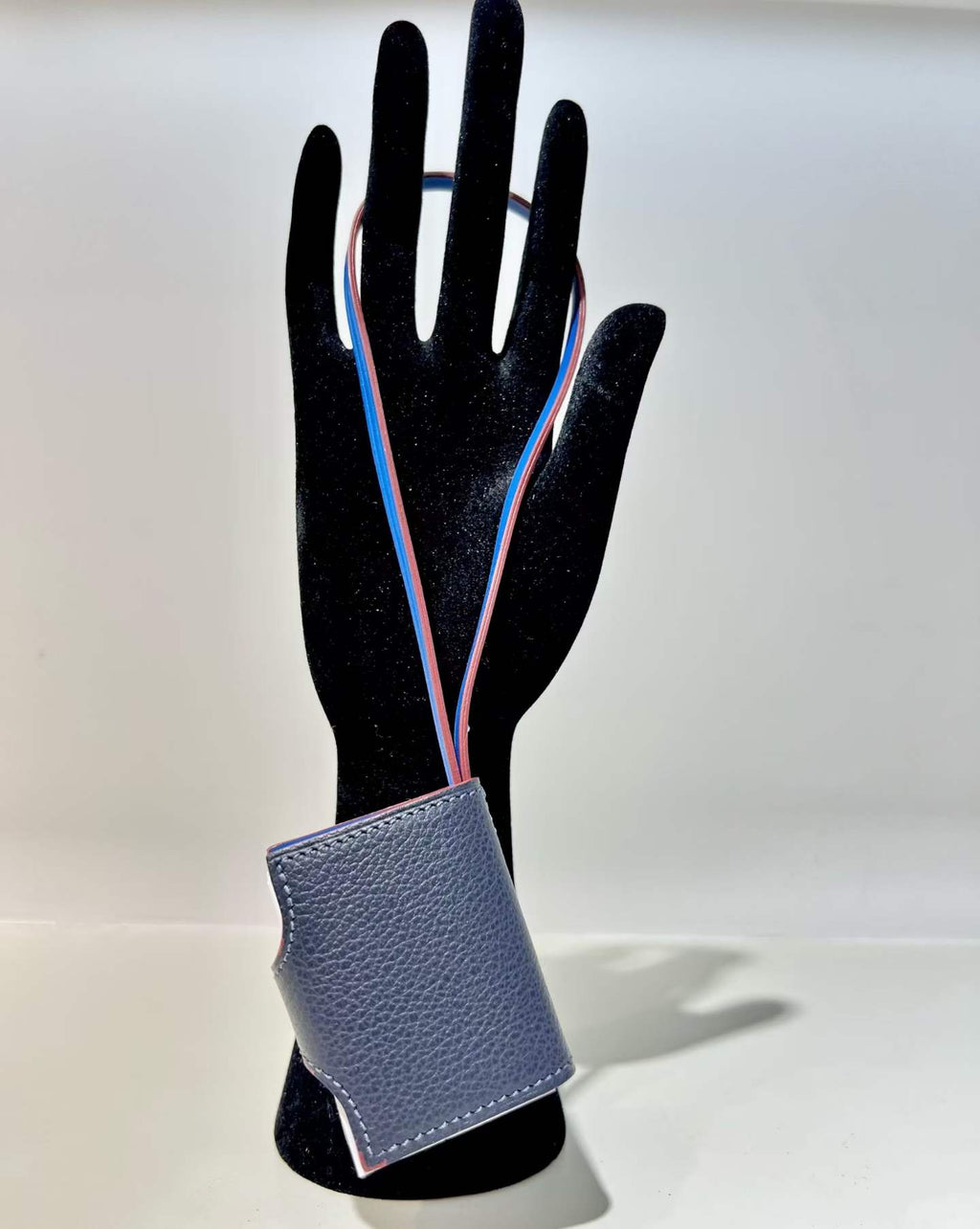Back view of navy blue hand-stitched leather book bag charm