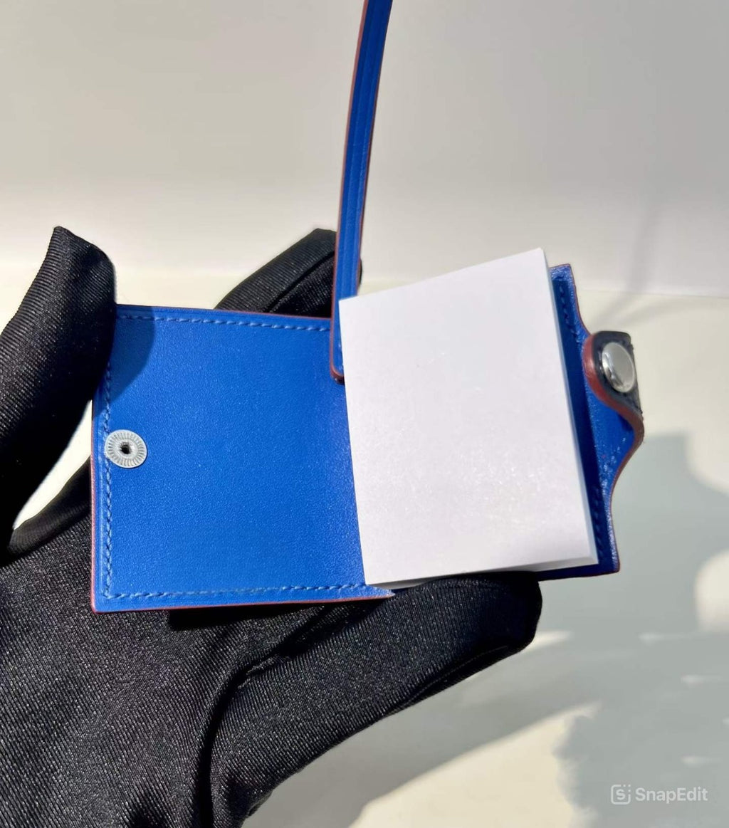 Inside view of navy blue hand-stitched leather mini notebook bag charm