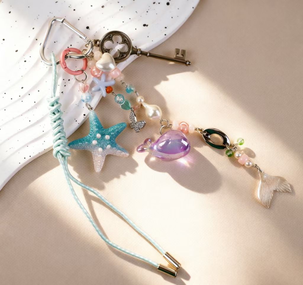Close view of a pastel ocean bag charm with starfish and decorative key