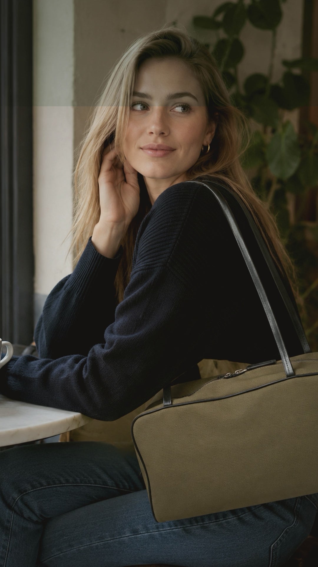 Woman showcasing the Canvas & Lambskin Minimalist Lightweight Commuter Tote, a genuine leather handbag in minimalist design.