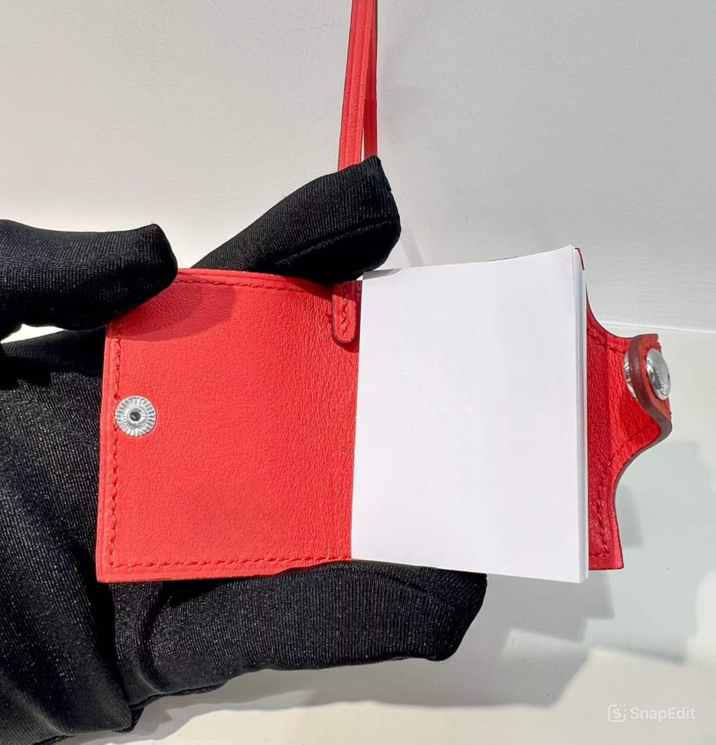 Inside view of red hand-stitched leather mini notebook bag charm