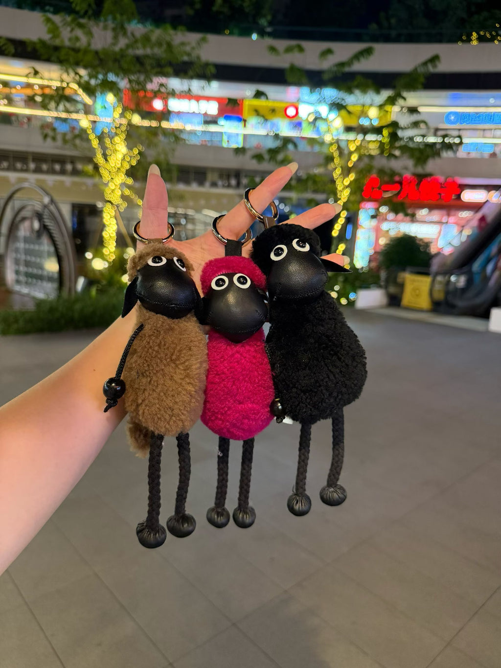 Camel red and black Shaun sheep bag charms shown together