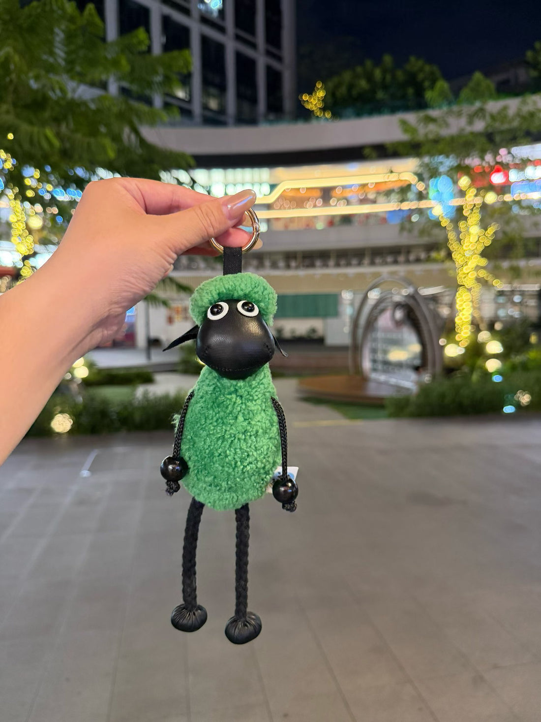 Bright green fluffy Shaun sheep bag charm with black face