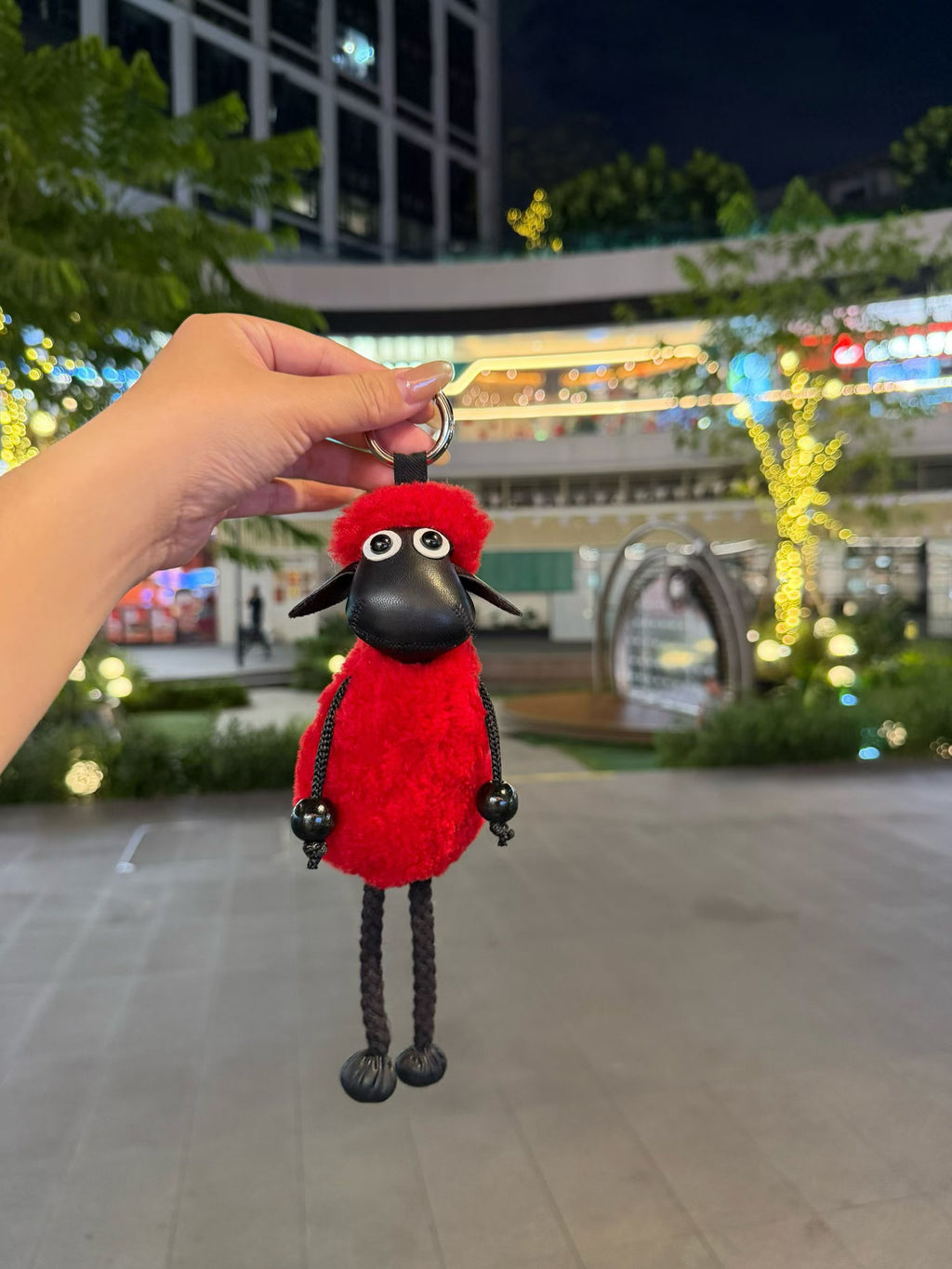 Red fluffy Shaun sheep bag charm with black faux leather face