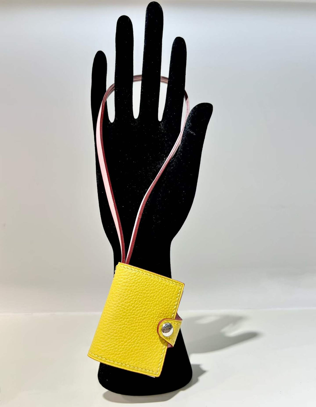 Back view of yellow hand-stitched leather book bag charm
