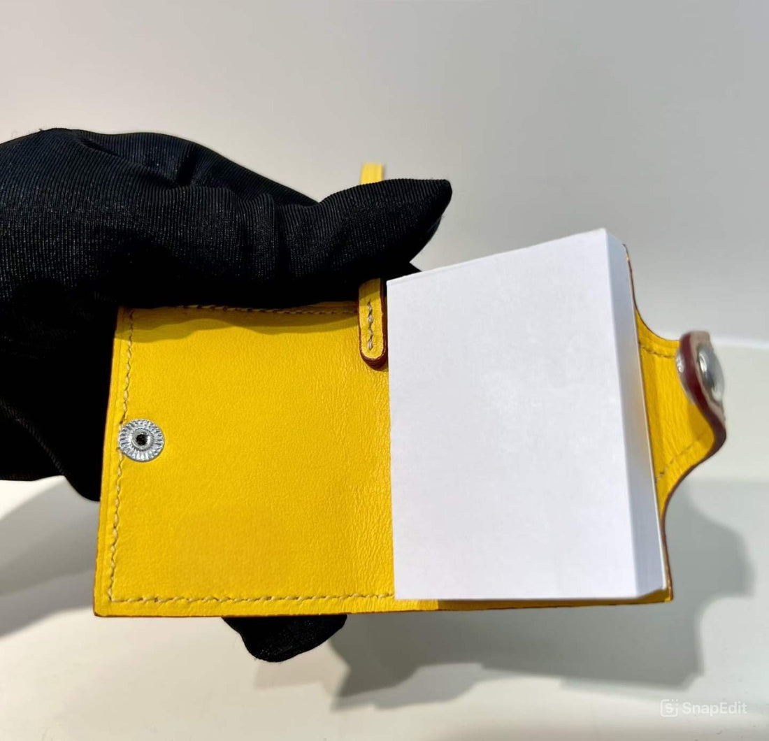 Inside view of yellow hand-stitched leather mini notebook bag charm